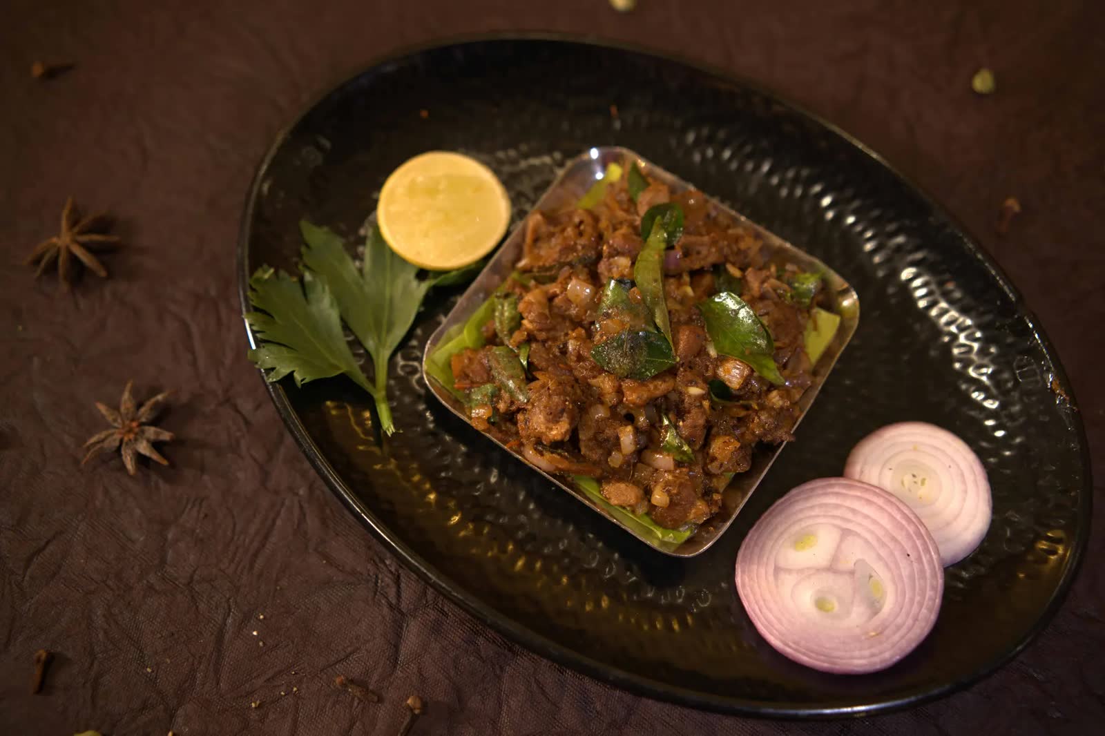 Mutton Chukka served with curry leaves and onions